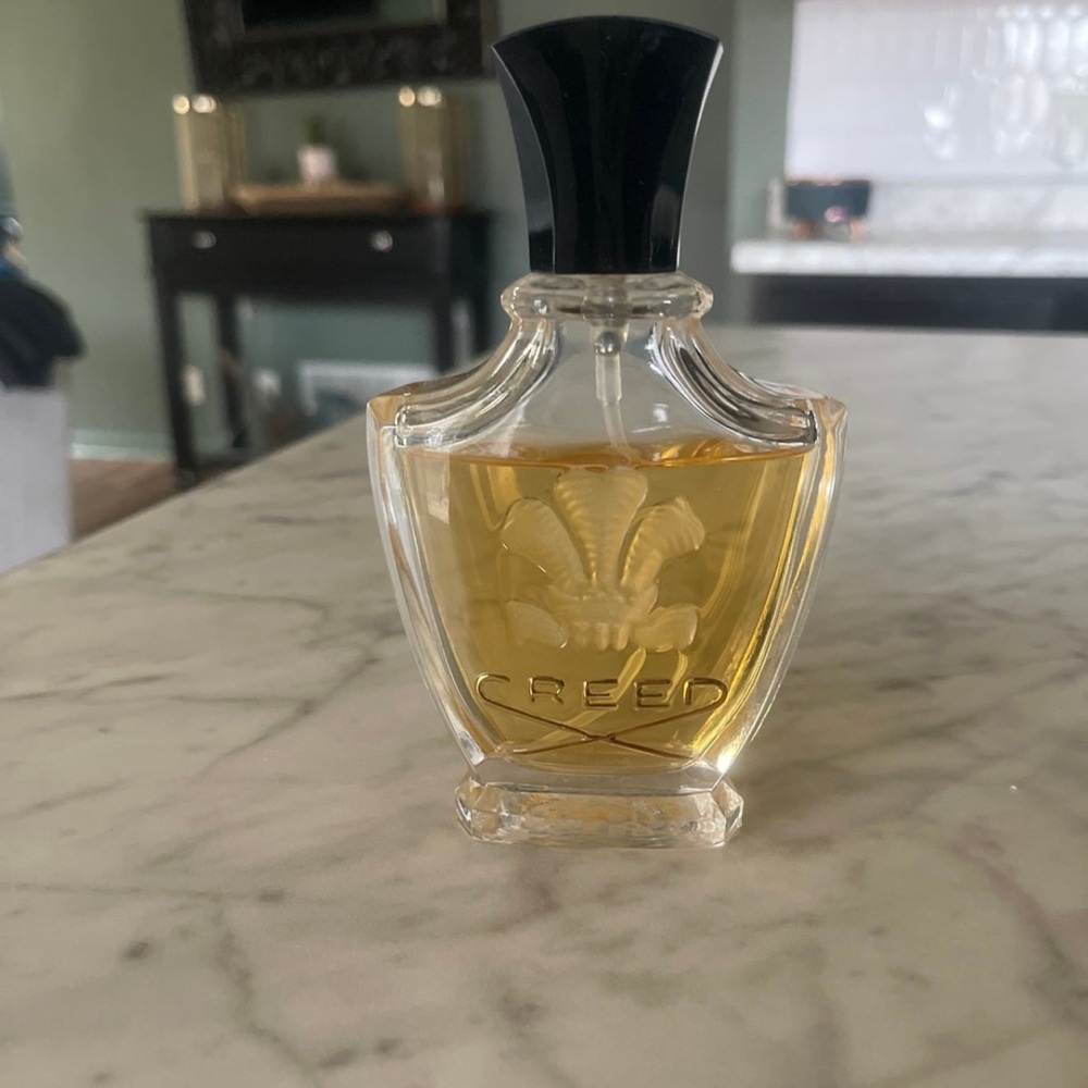 Creed Fragrance with Black Cap and Golden Hue